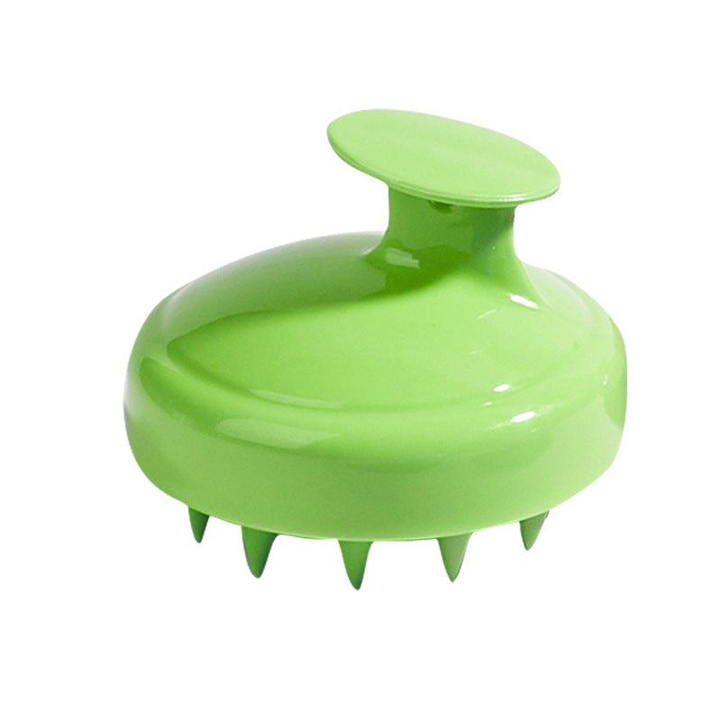 Brosse masseuse capillaire en silicone Racelya tenue en main